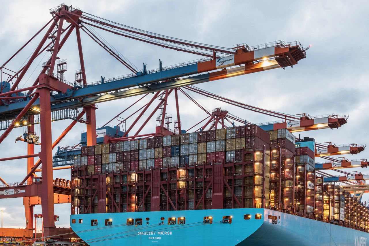 About A cargo ship loaded with containers at Hamburg's bustling commercial dock.